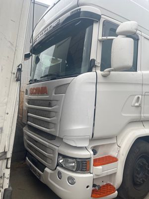 a white truck that is parked next to a building