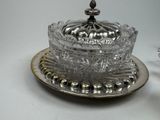 a silver plate with a glass bowl on it and a silver plate with a glass bowl on it