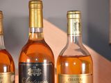 three bottles of wine sitting on a table next to each other