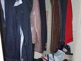a picture of a closet with clothes and shoes
