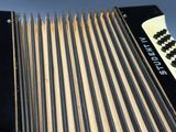 a close up of a black and white accordion on a table