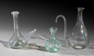 three glass vases that are sitting on a table