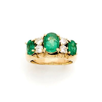 an emerald and diamond three stone ring