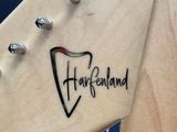 a close up of a guitar neck with a logo on it