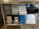 a stainless steel work table with pots and pans on it
