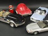 several toy cars are lined up in a row on a black surface