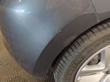 a close up of a car ' s front bumper and tire
