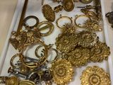 a display of gold jewelry on display in a glass case