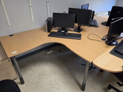 a desk with two computer monitors and a keyboard on it