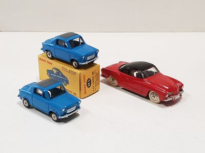 three toy cars sitting next to each other on a table