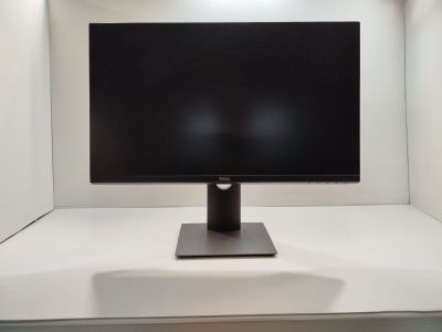 a computer monitor sitting on top of a white desk