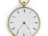 an old gold pocket watch with roman numerals and roman numerals on the face
