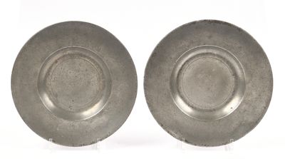 pair of silver plated dishes on stands on a white surface