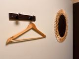 a mirror and a coat hanger hanging on a wall