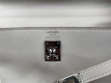 the inside of a white handbag with a silver handle