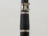 a close up of a pen with a black body and gold trim