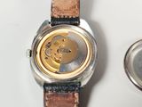 a watch that is sitting on a table next to a watch