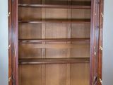 an image of a wooden bookcase with a glass door