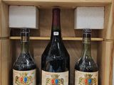 three bottles of wine in a wooden box