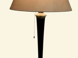 a lamp that is sitting on a table with a lamp shade on it