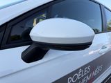a close up of a white car with a mirror on it