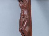 a wooden crucif with jesus on the cross on a blue background