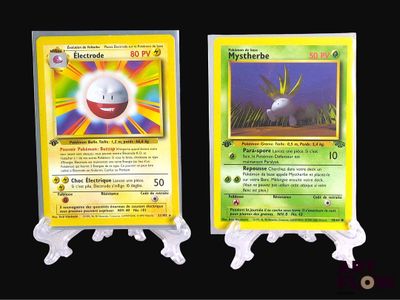 two pokemon cards are displayed on a black surface