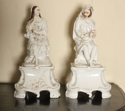 two figurines of a man and a woman on top of a table