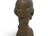 statue of a man ' s head on a white surface with a white background