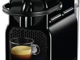 a black coffee machine with a cup of coffee in front of it