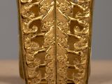 a close up of a gold ring on a table
