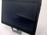 a tablet computer sitting on a stand on a table
