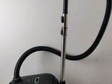 an image of a black vacuum cleaner sitting on top of a table