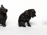 three figurines of dogs sitting next to each other