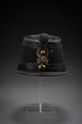 a black hat with a gold decoration on top of it
