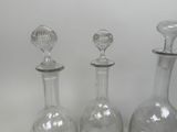 three glass vases sitting next to each other on a table