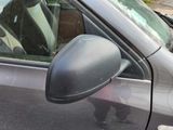a cat sitting in a car with its head out the window