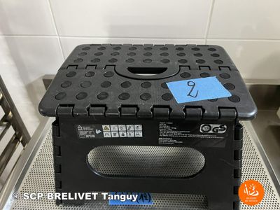a black plastic box with a blue tag on it