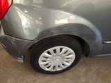 a car that has been dented and is in a garage