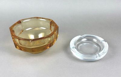 a glass ashtray and a glass ashtray on a table