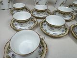 a lot of cups and saucers on the table
