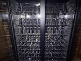 a wine cooler with a lot of glasses in it