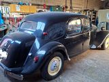 a black car that is parked in a garage