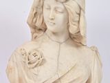 a statue of a woman holding a flower in her hand