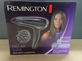 packaging of a hair dryer sitting on top of a wooden table