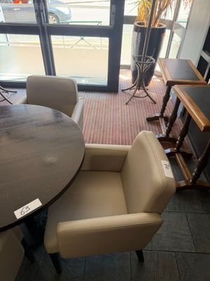 a table and chairs in a room with a large window
