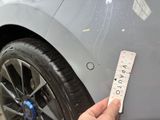 someone is measuring the width of a car tire with a ruler