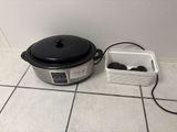 an image of a crock pot and a container on the floor