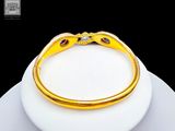 yellow gold bracelet with blue sapphires and diamonds on top of a white plate