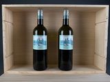 two bottles of wine sitting in a wooden box